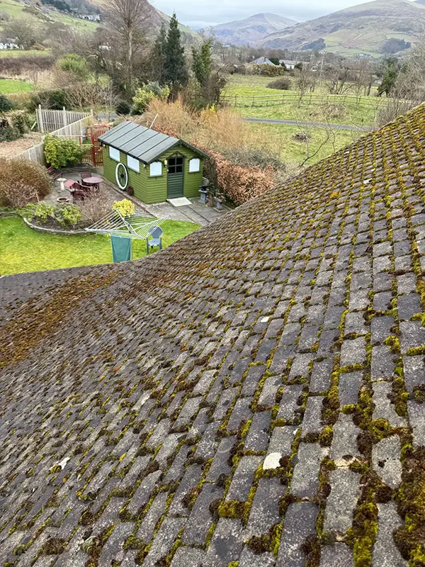 Photograph of a roof being pressure washed clean by Rickard Cleaning Services, Tywyn