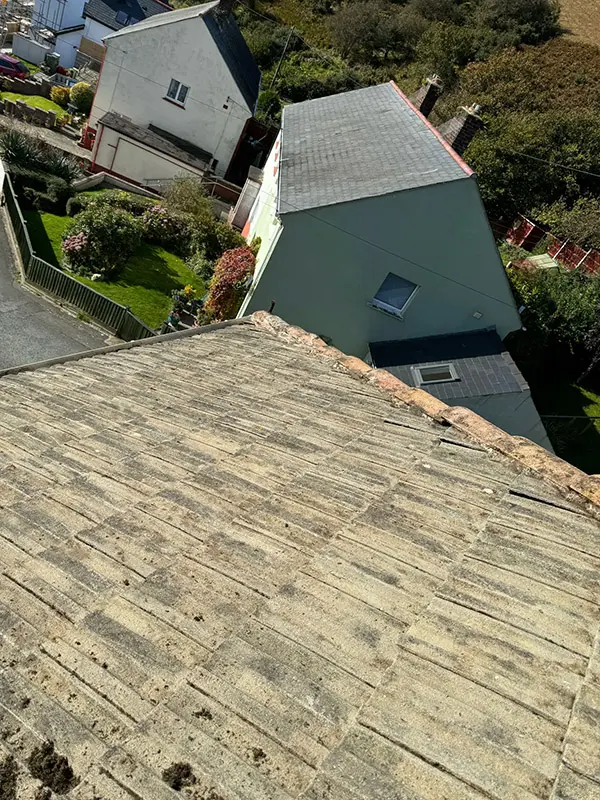 Photograph of a roof being pressure washed clean by Rickard Cleaning Services, Tywyn