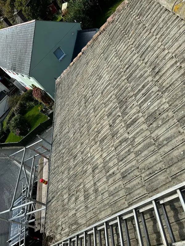 Photograph of a roof being pressure washed clean by Rickard Cleaning Services, Tywyn
