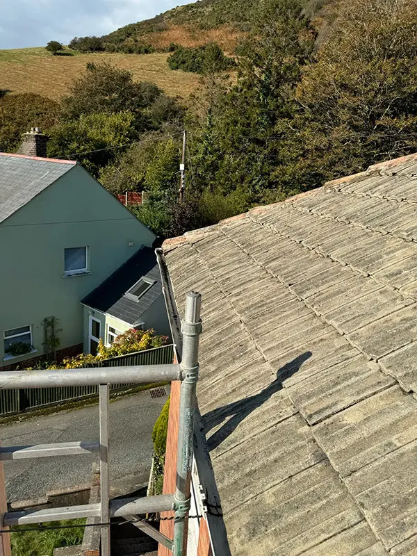 Photograph of a roof being pressure washed clean by Rickard Cleaning Services, Tywyn
